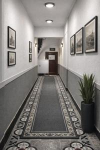 a hallway with a tile floor and a hallway with a door at Balat Life Suites in Istanbul