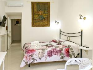 a bedroom with a bed and a painting on the wall at Il Veliero B&B in Gaeta +36 photos