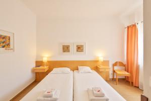 a bedroom with a bed with two towels on it at ABLA Guest House in Carcavelos +87 photos