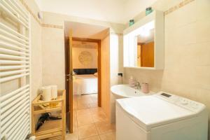 a bathroom with a sink and a washing machine at Le Contrade via Roma in Monopoli