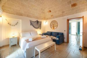 a hotel room with a bed and a couch at Le Contrade via Roma in Monopoli