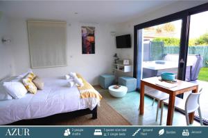 a bedroom with a bed and a table and a desk at Cote Ouest in Sévrier
