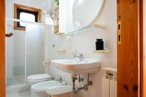 a bathroom with a sink and a toilet and a mirror at Sila Magico Incanto in Camigliatello Silano +47 photos