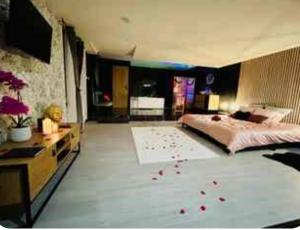 a bedroom with a large bed with red roses on the floor at Saphir in Plouray