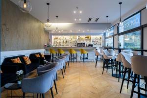 a restaurant with chairs and a bar at Grand Hôtel & Spa Uriage in Uriage-les-Bains
