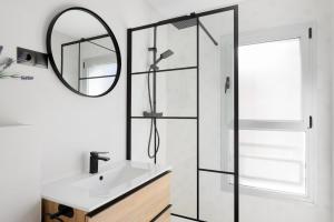 a bathroom with a sink and a mirror at MÁ HOMES Postigos in Málaga +56 photos