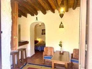 a room with a bed and a table and chairs at Casa Amigos Sorvilan - la Bodega in Sorvilán +28 photos