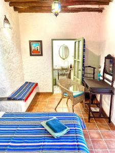 a bedroom with a bed and a table and a desk at Casa Amigos Sorvilan - la Bodega in Sorvilán
