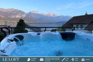 a hot tub with a view of the mountains at Cote Ouest in Sévrier