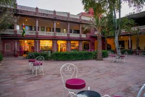 a courtyard with chairs and tables in front of a building at Ranbanka Palace in Jodhpur