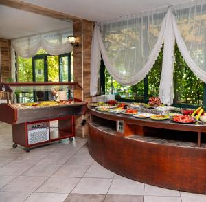 a buffet line with many different plates of food at Hotel Caesar Palace in Sunny Beach