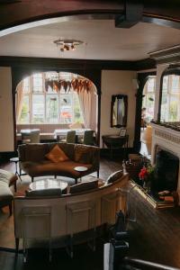a living room with a couch and a fireplace at The Coed-Y-Mwstwr Hotel in Bridgend +16 photos