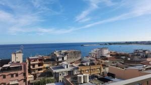 a view of a city with the ocean and buildings at Serenity Naxos Vacation Home in Giardini Naxos