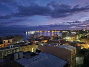 a view of a city at night at Serenity Naxos Vacation Home in Giardini Naxos +2 photos