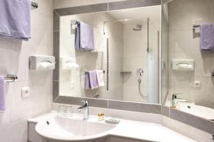 a bathroom with a sink and a mirror at Gasthof Bären in Holzgau +74 photos