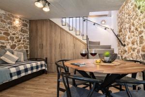 a room with a table and two glasses of wine at Armonia Cosy Loft Chora Samothraki View in Samothraki +7 photos