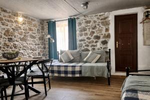 a living room with a bed and a table and a table sidx sidx at Armonia Cosy Loft Chora Samothraki View in Samothraki