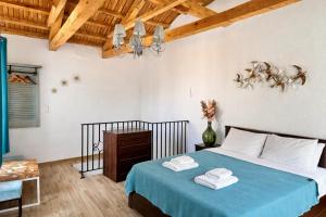 a bedroom with a bed with towels on it at Armonia Cosy Loft Chora Samothraki View in Samothraki