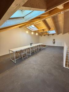 a large room with a long table in the ceiling at El Santo Hostel in Burgos