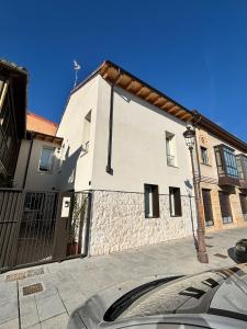 a white building on the side of a street at El Santo Hostel in Burgos