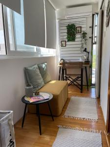 a living room with a couch and a table at Studio apartman Providenca in Split +7 photos