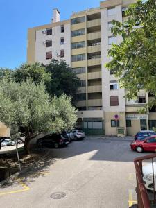 a parking lot in front of a large building at Studio apartman Providenca in Split