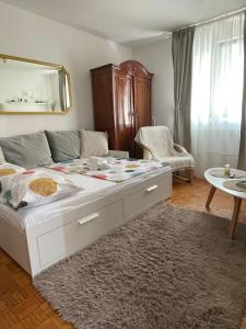 a bedroom with a large white bed with a rug at Studio apartman Providenca in Split