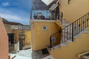 a view of a building with stairs and a balcony at Avgi's House Pelekas in Pelekas