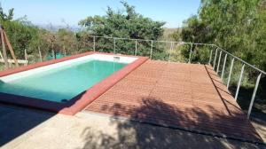 a swimming pool on the roof of a house at San Isidro Cabaña in Mendoza