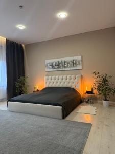 a bedroom with a large bed with lights on it at White Home by Gerda in Etgersleben