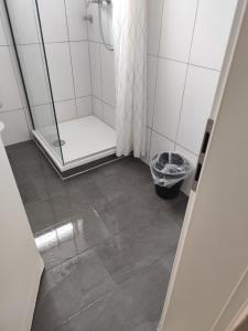 a shower with a glass door in a bathroom at GZ Hostel Bonn in Bonn
