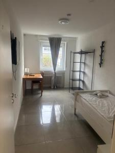 a room with a bed and a desk and a window at GZ Hostel Bonn in Bonn +49 photos