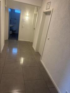 a hallway with a toilet and a tile floor at GZ Hostel Bonn in Bonn