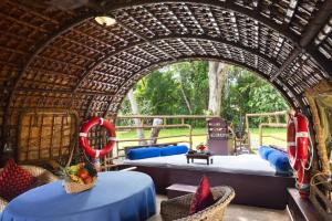 a resort room with two beds in a bamboo tunnel at Spice Coast Cruises - Houseboat, A CGH Earth Experience in Alleppey