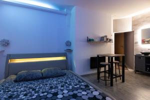 a bedroom with a bed and a table in a room at LX202 Love Room & Spa privatif - Jacuzzi & Sauna in Dijon +3 photos