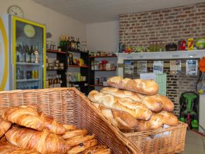 a bakery with baskets of loaves of bread on display at Camping les 3 Sablières in Saint-Firmin