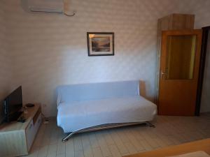 a hospital room with a bed and a door at Apartments Mara Mandre in Mandre