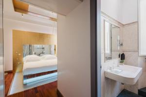 a bedroom with a bed and a bathroom with a sink at Hotel Trecento in Rome +98 photos