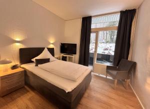 a hotel room with a bed and a window at Kurhaus im Harz - Bad Harzburg in Bad Harzburg