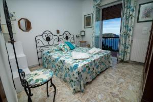 a bedroom with a bed and a chair and a window at Villa Ciacia in Cervo +29 photos