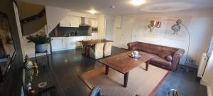 a living room with a couch and a table at B&B Velddriel in Velddriel