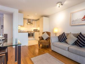 a living room with a couch and a table at Curlew in Poole