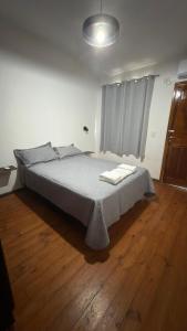 a bedroom with a bed with two towels on it at Yvyrá Duplex in Eldorado +6 photos