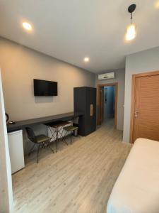 a hotel room with a bed and a desk and a tv at Ore Pera Suites in Istanbul