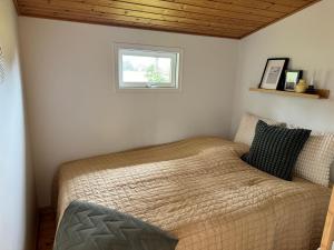 a bed in a bedroom with a window at Hedebo Strand Camping in Sæby +101 photos
