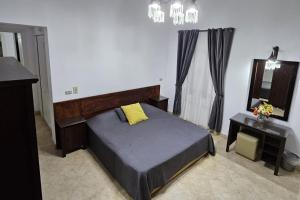 a bedroom with a bed and a vanity and a mirror at Private Villa Heated Pool & Enclosed Garden in Hurghada