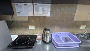 a kitchen counter top with a tray and a sink at Yvyrá Duplex in Eldorado