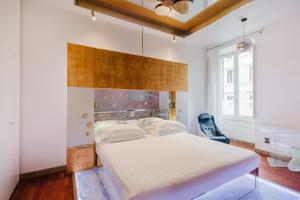 a bedroom with a large bed with a wooden headboard at Hotel Trecento in Rome