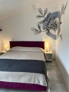 a bedroom with a bed and two tables with lamps at B&B da Nic e Ste in Casalbordino
