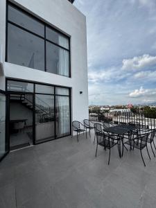 a patio with tables and chairs on a building at Penthouse Panoramic Terrace, San Felipe in Chihuahua